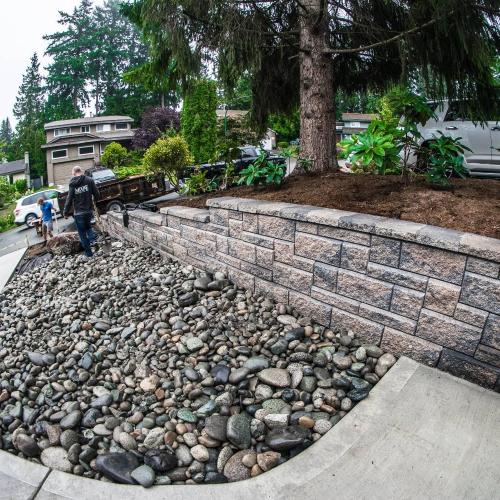  | A new "broom finish" concrete driveway with an Allan Block Wall (Rocky Mountain Blend, Ashlar Pattern) and some beautiful river rock to tie it all in. | Retaining Walls & Borders - Design and Installation 